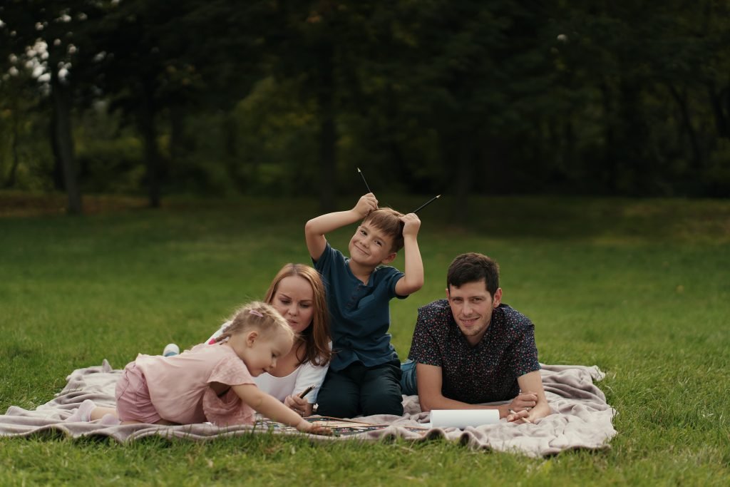 Two siblings of different ages playing together peacefully, highlighting reduced sibling rivalry with big age gap.