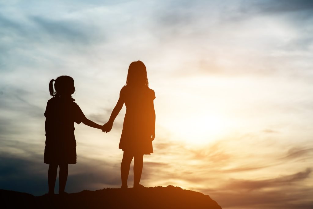 Child helping elderly person with groceries, symbolizing kindness and empathy in children.